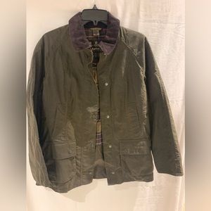 The Original Barbour Tarlan cotton Wax Jacket. Dark green, almost brown looking.